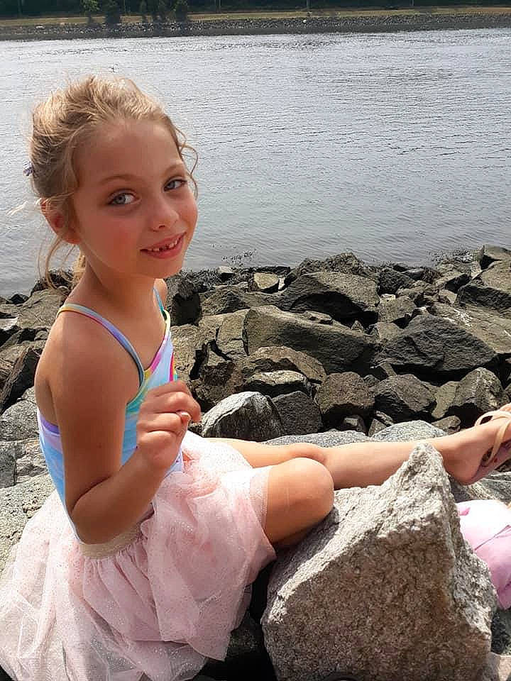 Savanah joined the competition — help win amazing prizes! ballet_tutu, child, costume, dress, fun, joy, leg, person, pink, rock, sitting, smile, summer, toddler, vacation, water