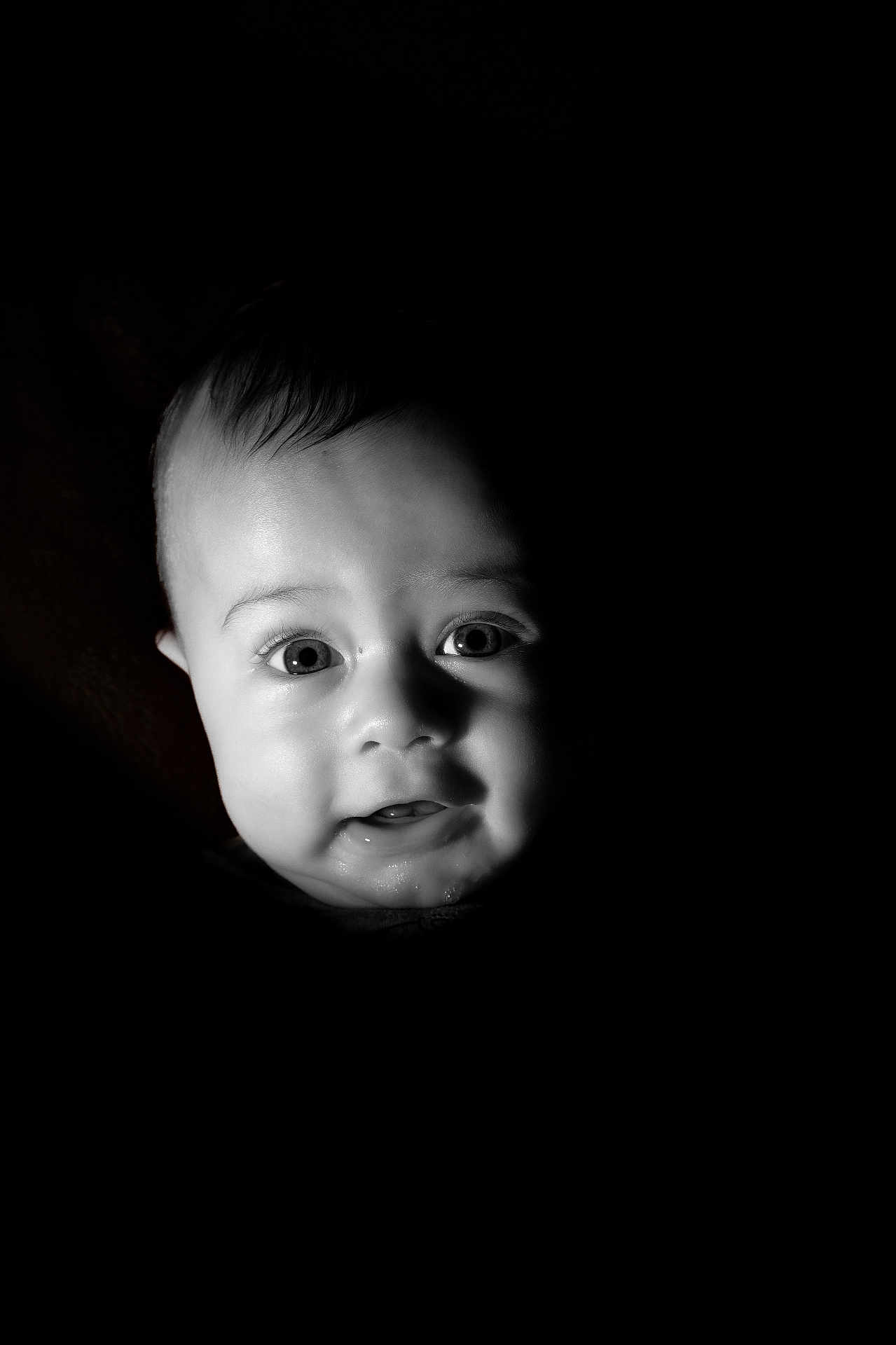 Carlos joined the competition — help win amazing prizes! baby, face, portrait, infant, black_background, expression, cute, child, closeup, eyes, mouth, skin, head, newborn, person, young, adorable, innocent, light, shadow