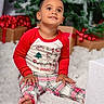 child, toddler, pajamas, holiday, christmas, presents, gift, red, plaid, smiling, sitting, face, cute, indoor, decorations, festive, tree, celebration, young, happy
