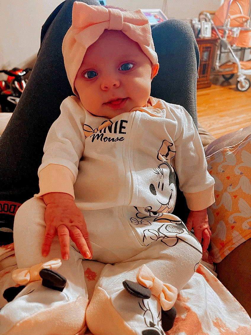 Briella joined the competition — help win amazing prizes! baby, baby_safety, baby_toddler_clothing, chair, cheek, child, comfort, finger, fun, happy, headwear, orange, person, sitting, skin, sleeve, t_shirt, textile, thigh, tire