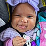 Izzy is registered to the contest to win money with this photo: baby, infant, smiling, pacifier, headband, purple_clothing, blanket, car_seat, child, cute, hand, portrait, happy, closeup, face, cozy, newborn, infant_clothing, wrapped, seatbelt