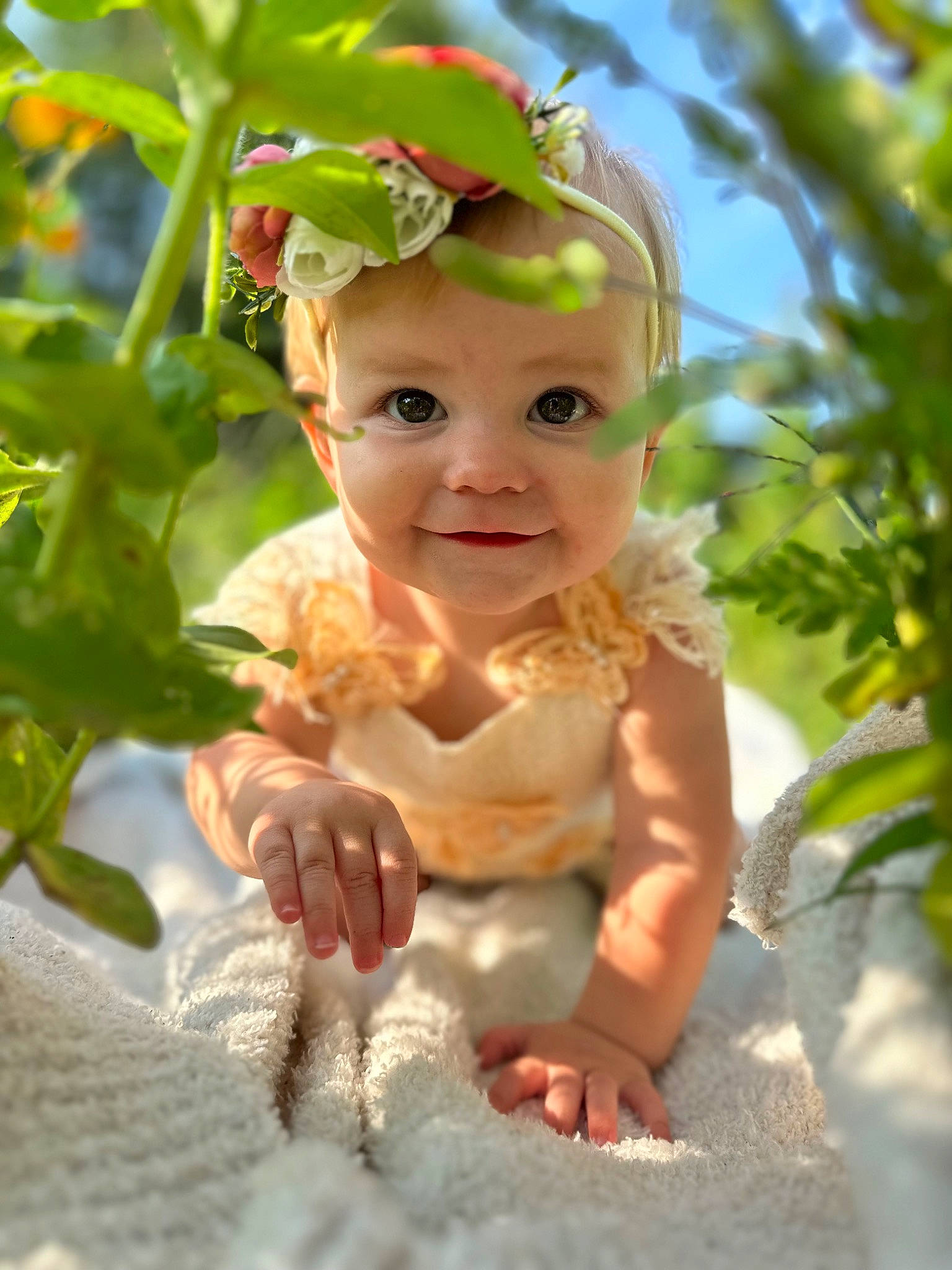 Geneva is registered to the contest to win money with this photo: baby, baby_toddler_clothing, botany, child, eye, fashion_accessory, flower, fun, grass, happy, head, headband, headpiece, headwear, leaf, people_in_nature, person, petal, plant, smile