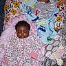 Imani is registered to the contest to win money with this photo: baby, blanket, child, comfort, cozy, cute, cute_clothing, floral_pattern, indoor, infant, nursery, onesie, peaceful, person, pillow, portrait, rest, sleeping, soft, toddler