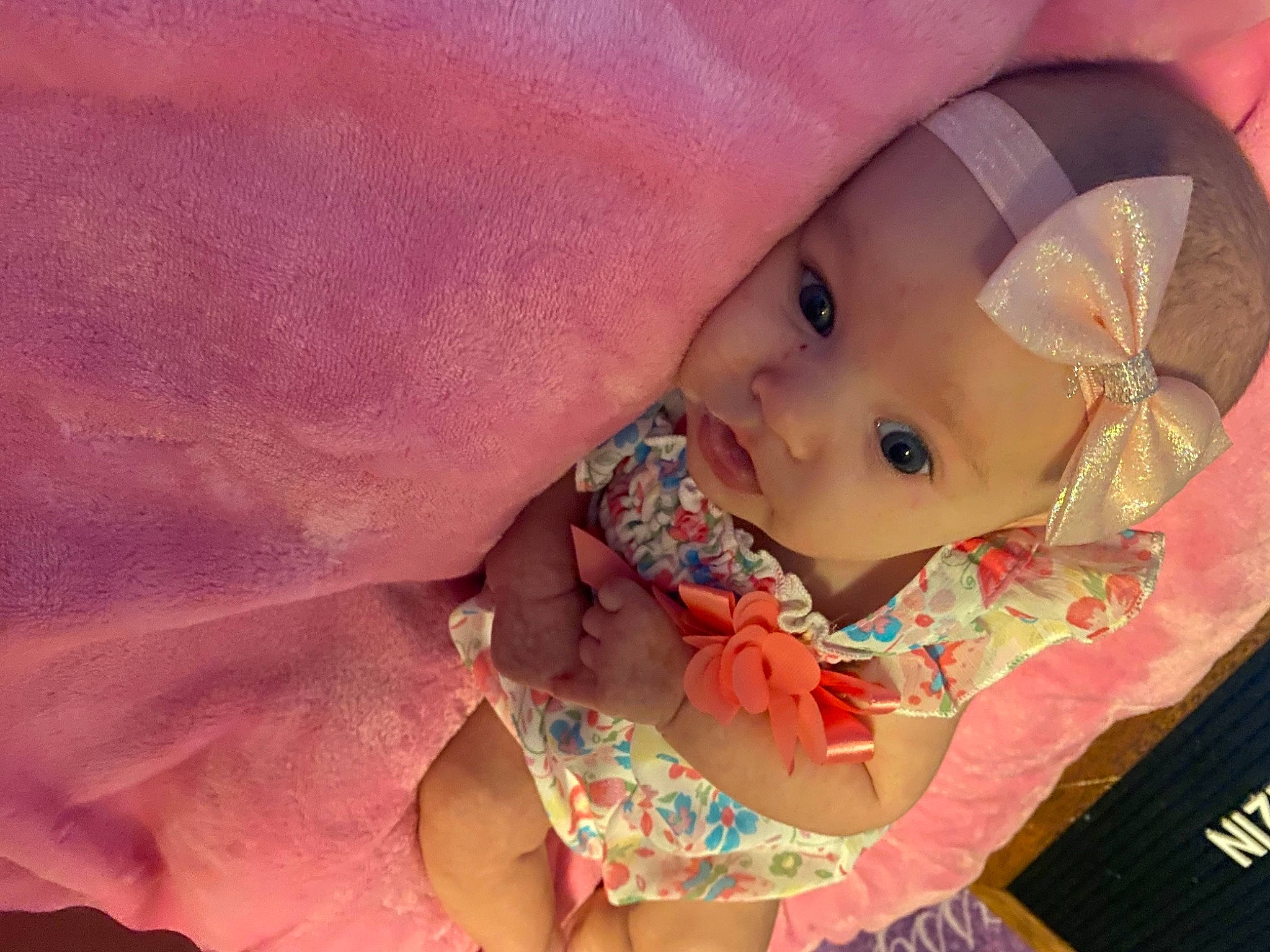 Paisley is registered to the contest to win money with this photo: baby, baby_products, baby_toddler_clothing, cheek, comfort, dress, eye, face, finger, happy, head, headwear, human_body, iris, lip, mouth, nail, nose, person, pink