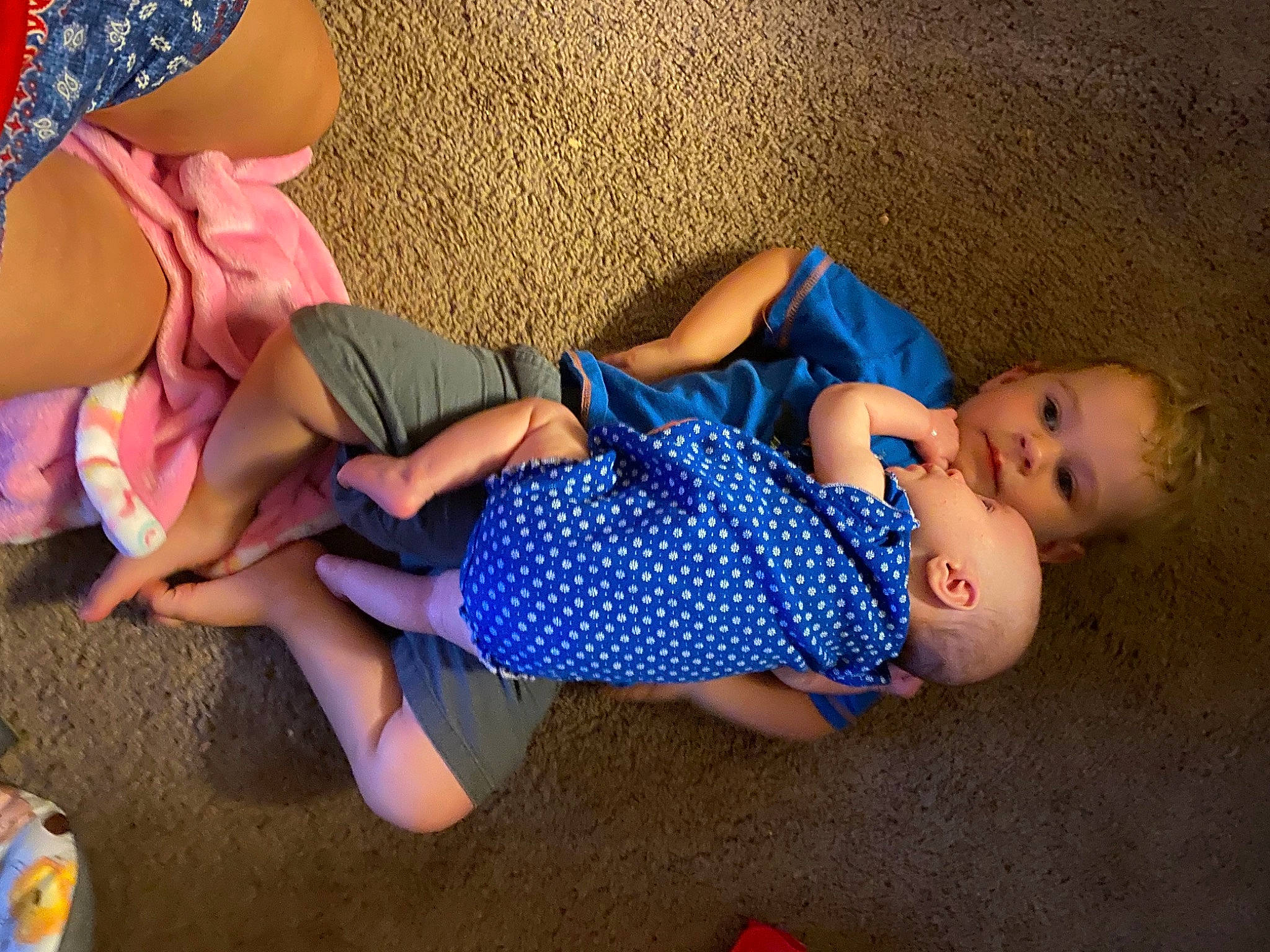 Raiden is registered to the contest to win money with this photo: arm, baby_toddler_clothing, barefoot, blue, child, electric_blue, finger, flooring, foot, fun, human_body, human_leg, joint, knee, leg, leisure, person, textile, thigh, toddler