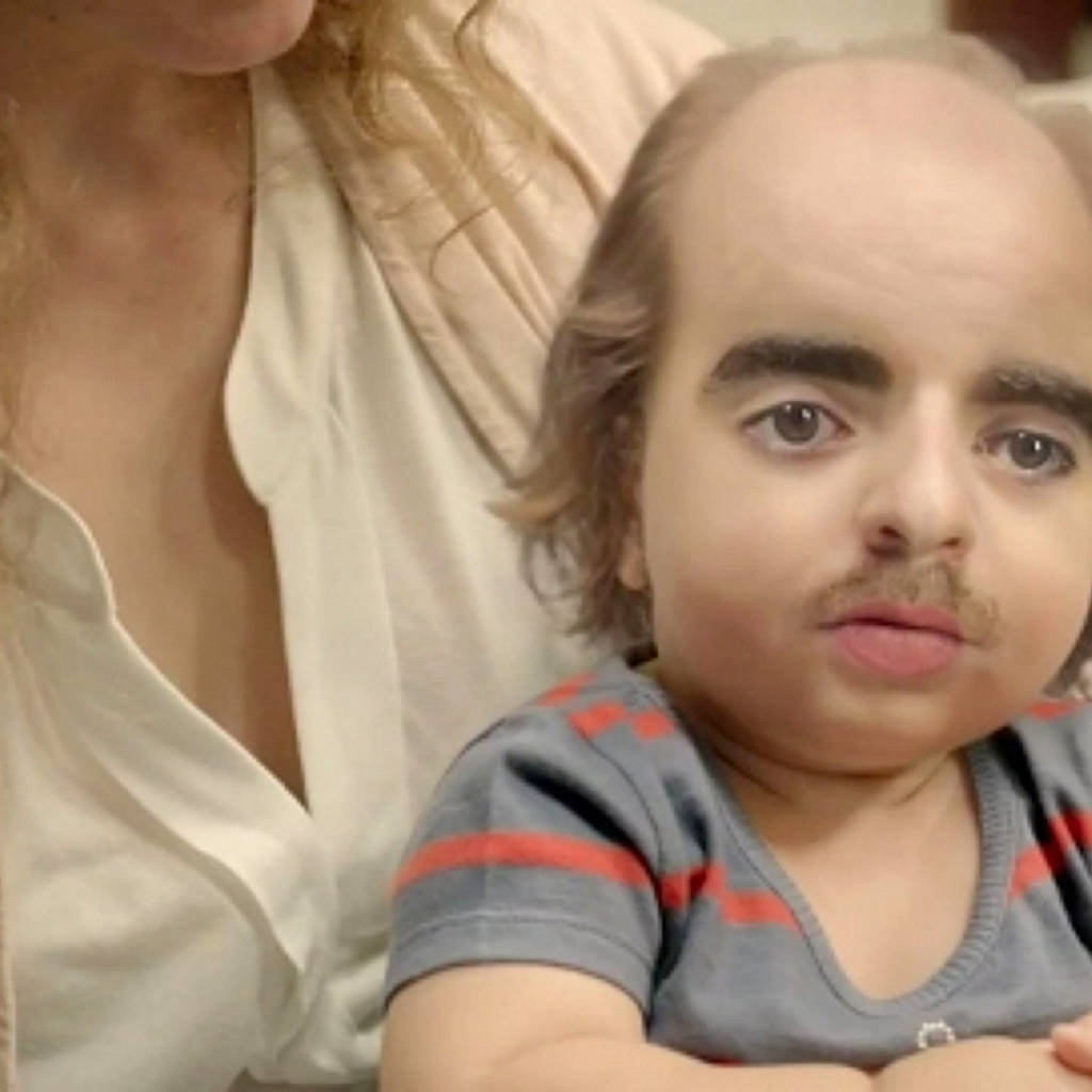 Luther is registered to the contest to win money with this photo: cheek, child, chin, comfort, ear, eyelash, finger, fun, gesture, happy, mouth, neck, nose, person, portrait_photography, selfie, sitting, t_shirt, toddler, vacation