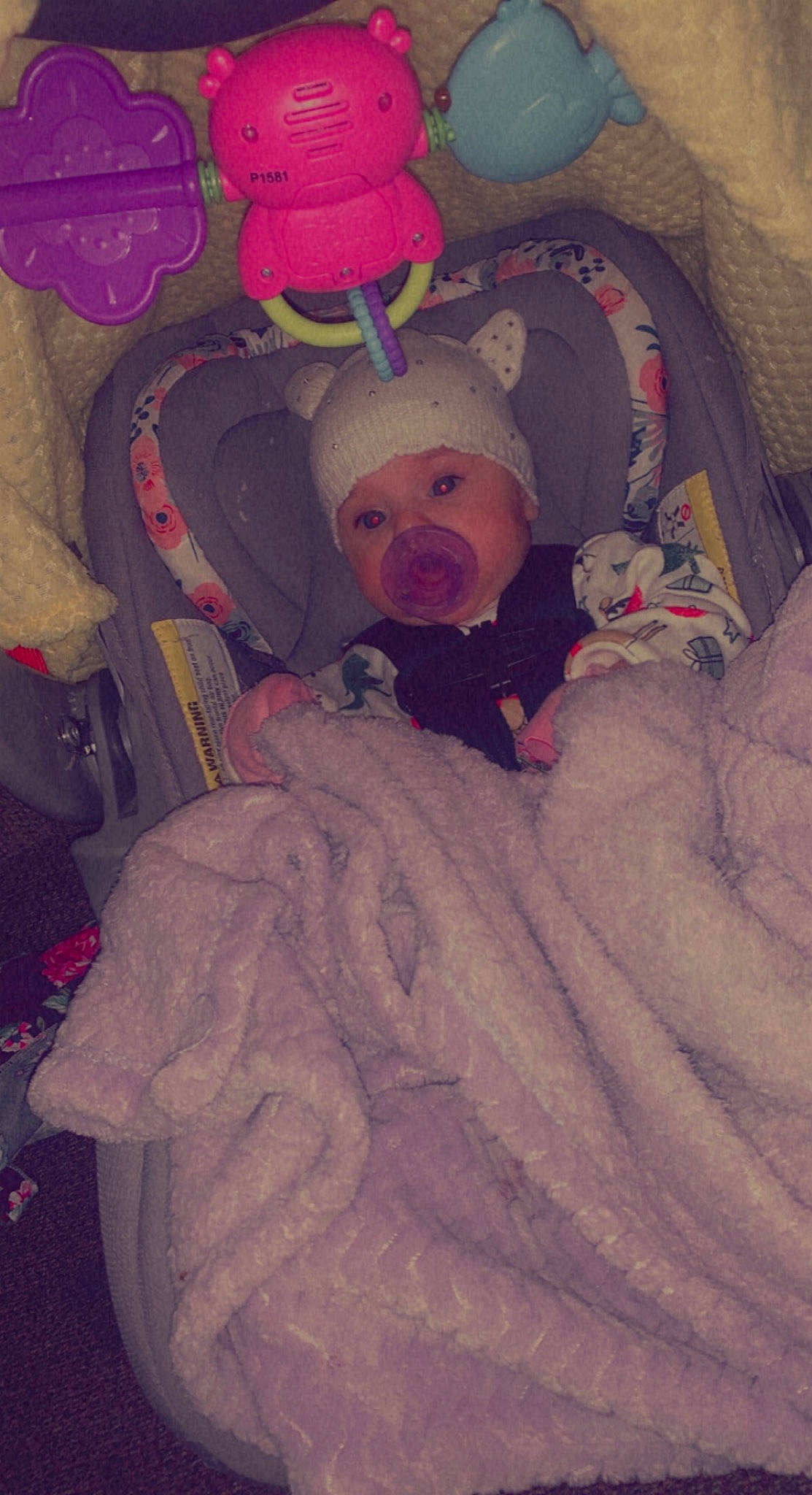 Ariella joined the competition — help win amazing prizes! baby, baby_products, baby_safety, baby_toddler_clothing, beanie, carmine, child, comfort, eye, fun, happy, headwear, human_body, lap, magenta, person, pink, room, sitting, smile