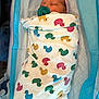Zoey is registered to the contest to win money with this photo: newborn, baby, pacifier, blanket, duck_pattern, hospital, bassinet, sleeping, infant, wrapped, headwear, cotton, soft, cute, child, bed, rest, peaceful, warm, comfort