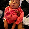 Jaliyah joined the competition — help win amazing prizes! baby, infant, newborn, clothing, hat, hand, tattoo, blanket, bottle, person, skin, cute, sleepy, indoors, resting, pink, white, black, portrait, holding
