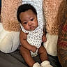 Jaliyah is registered to the contest to win money with this photo: baby, infant, child, sitting, onesie, socks, pillow, plush, tattoo, arm, soft, comfort, indoor, portrait, cute, expression, face, skin, person, cozy