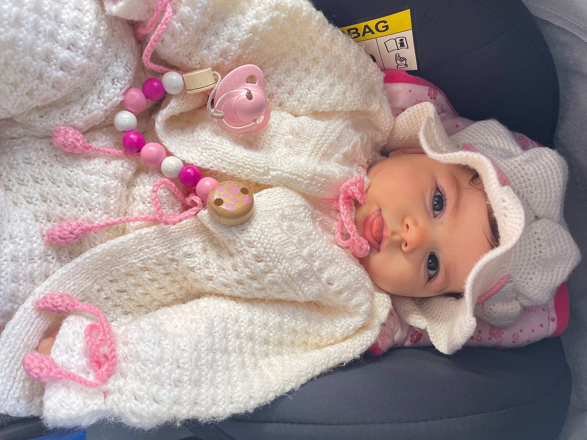 Eloise participe au concours pour gagner de l'argent avec cette photo : baby, baby_toddler_clothing, cheek, child, clothing, comfort, doll, eyelash, headgear, headwear, iris, knit_cap, linens, lip, person, pink, product, skin, textile, toddler