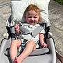 baby, baby_rocker, child, clothing, concrete, cute, daylight, foot, grass, hand, happy, infant, outdoor, person, pillow, red_hair, relaxing, seat_belt, smiling, sunlight