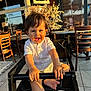 Milan joined the competition — help win amazing prizes! baby, barefoot, child, cute, daylight, face, flower_arrangement, furniture, happy, high_chair, indoor, person, portrait, restaurant, smiling, sunlight, table, toddler, white_shirt, wooden_chair
