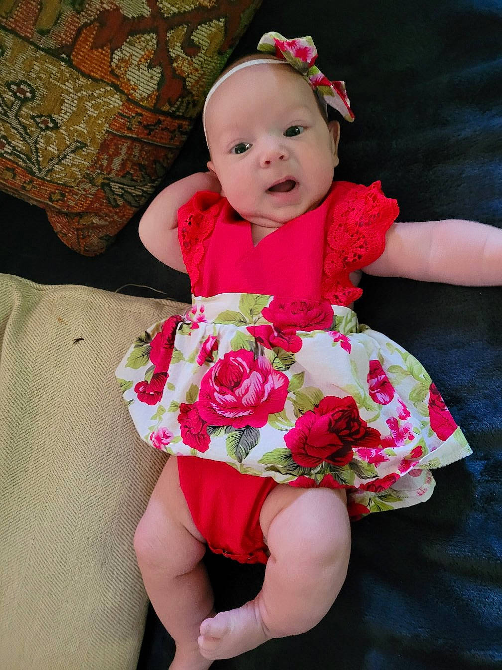 Oaklee is registered to the contest to win money with this photo: baby, baby_toddler_clothing, bouquet, child, cut_flowers, dress, embellishment, flower, flower_arranging, happy, headpiece, headwear, magenta, pattern, person, petal, pink, plant, sleeve, smile