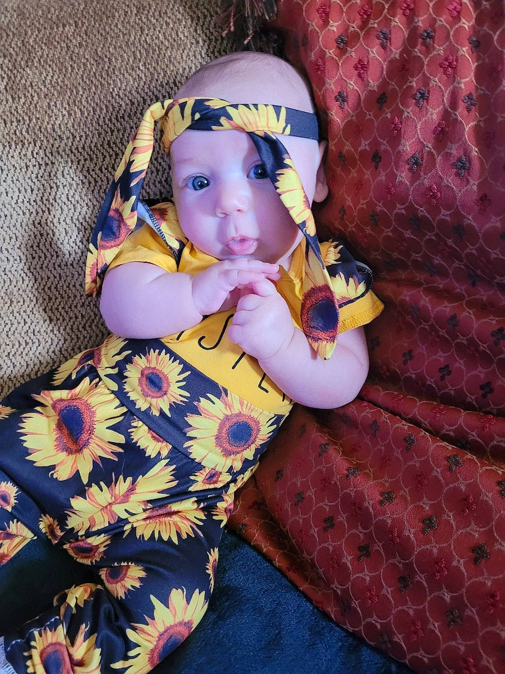 Oaklee is registered to the contest to win money with this photo: baby, baby_products, baby_toddler_clothing, child, comfort, doll, fashion_accessory, fashion_design, fun, goggles, happy, headwear, linens, magenta, pattern, person, personal_protective_equipment, purple, sitting, textile