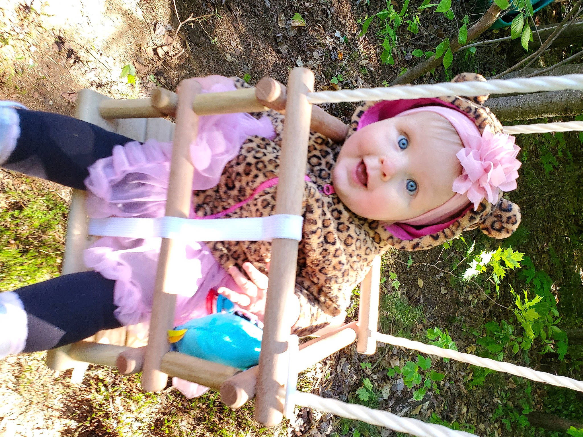 Megan participe au concours pour gagner de l'argent avec cette photo : baby_toddler_clothing, botany, child, doll, fawn, grass, happy, headwear, leisure, magenta, outdoor_furniture, pattern, people_in_nature, person, pink, plant, purple, smile, summer, textile