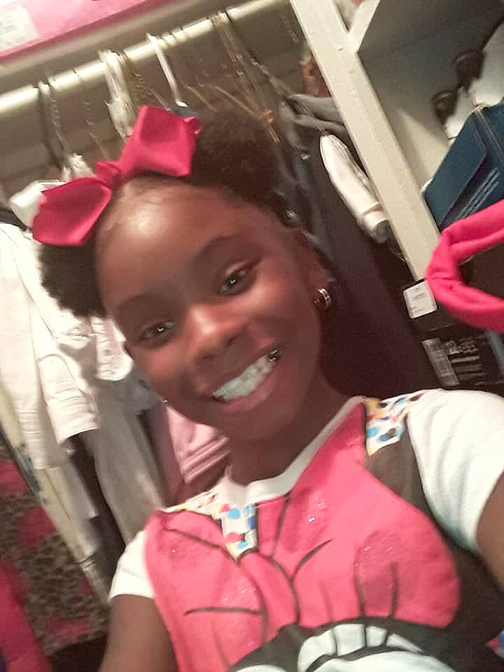 Kamauri Clay is registered to the contest to win money with this photo: black_hair, car_seat, cheek, child, cool, fun, hair, head, joy, person, pink, selfie, smile, toddler