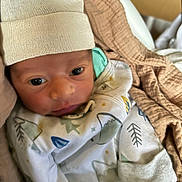 Christoforos joined the competition — help win amazing prizes! baby, newborn, infant, hat, blanket, clothing, face, person, wrapped, cute, soft, warm, indoors, cozy, sleepwear, young, headwear, portrait, child, newborn_baby