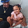 Serenity joined the competition — help win amazing prizes! blanket, braided_hair, cap, casual_clothing, child, couch, cozy, diaper, family, gold_necklace, hand, happy, indoor, man, phone, pink_shirt, seated, skin_tone, smile, tattoo