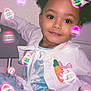 blue_dress, bunny_pattern, carrot_patch, chair, child, colorful, curly_hair, cute, easter_eggs, festive, girl, glowing_effects, happy, holiday, indoor, pigtails, playful, portrait, smiling, white_jacket