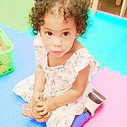 Juliana Carpenter joined the competition — help win amazing prizes! child, toddler, curly_hair, floral_dress, blue_leggings, toy, colorful_mats, indoor, playtime, sitting, brown_toy, curious_expression, floor, plastic_basket, footwear, young_child, playroom, cute, looking_up, person