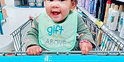Juliana Carpenter joined the competition — help win amazing prizes! toddler, child, shopping_cart, store, aisle, shelves, products, baby, curly_hair, green_bib, blue_jeans, happy, smiling, hands, shopping, retail, indoor, person, casual_clothing, bracelet