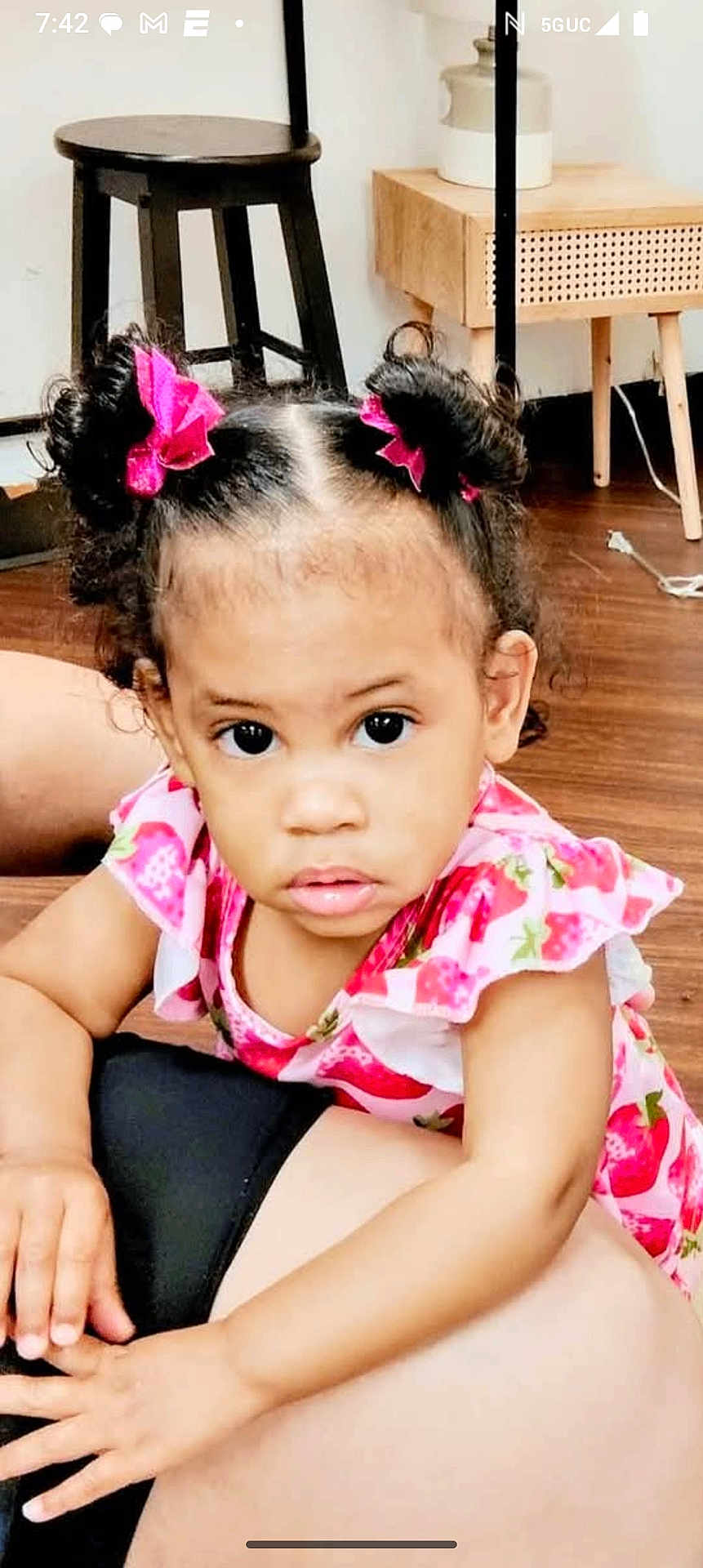 Juliana Carpenter is registered to the contest to win money with this photo: toddler, child, girl, pink_bows, strawberry_dress, curly_hair, indoor, wooden_floor, furniture, stool, table, person, face, hands, expression, young_child, cute, curious, bright_eyes, home