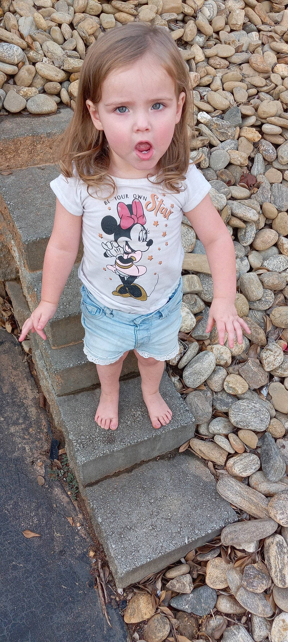 Karma is registered to the contest to win money with this photo: baby_toddler_clothing, blue, eye, facial_expression, grass, hand, head, organ, people, person, photograph, pink, red, road_surface, shorts, skin, sleeve, summer, surprise, t_shirt