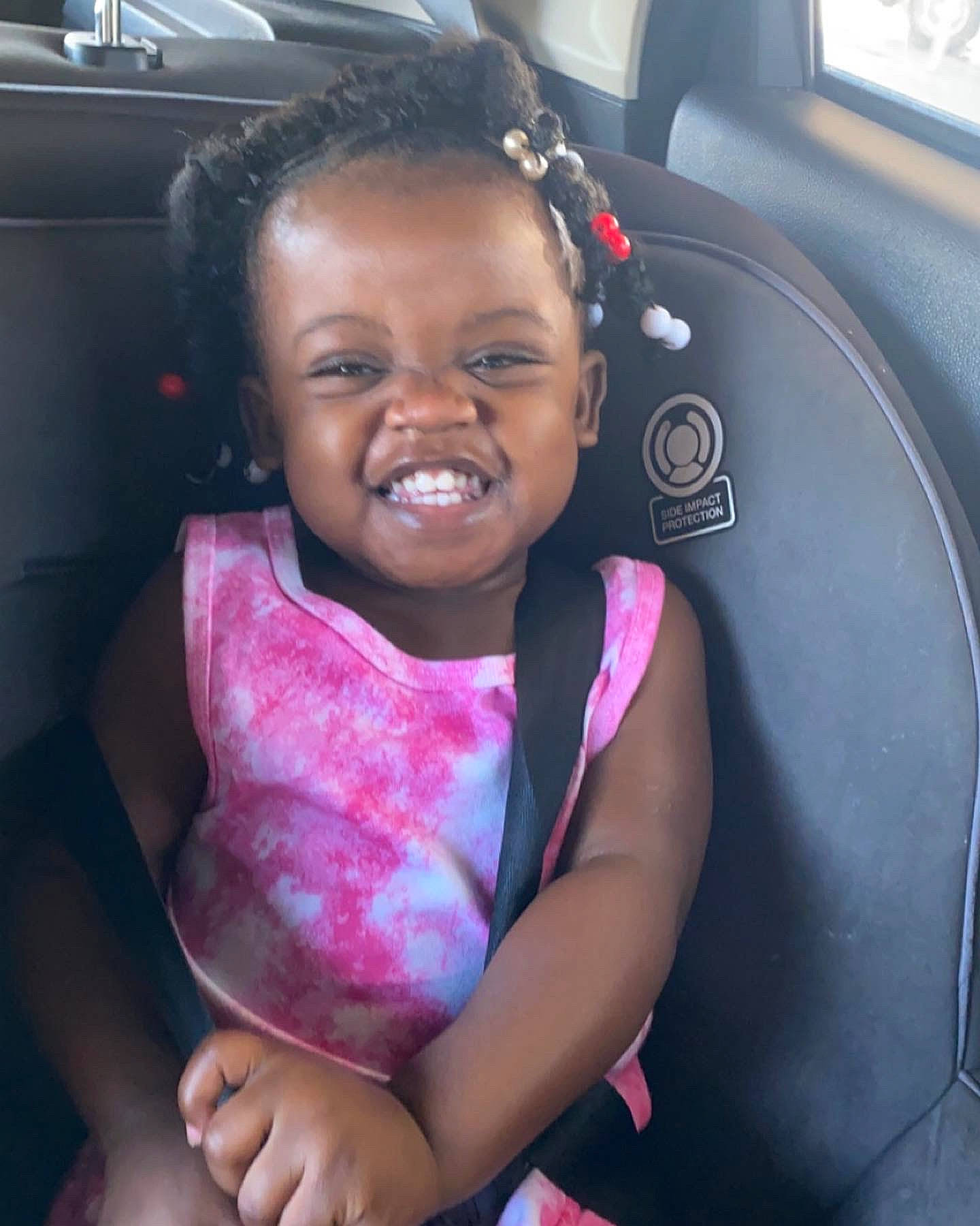 Serenity is registered to the contest to win money with this photo: automotive_design, car_seat, cool, dress, eye, face, gesture, hair, hairstyle, hand, happy, lip, motor_vehicle, mouth, person, pink, product, skin, smile, vehicle_door