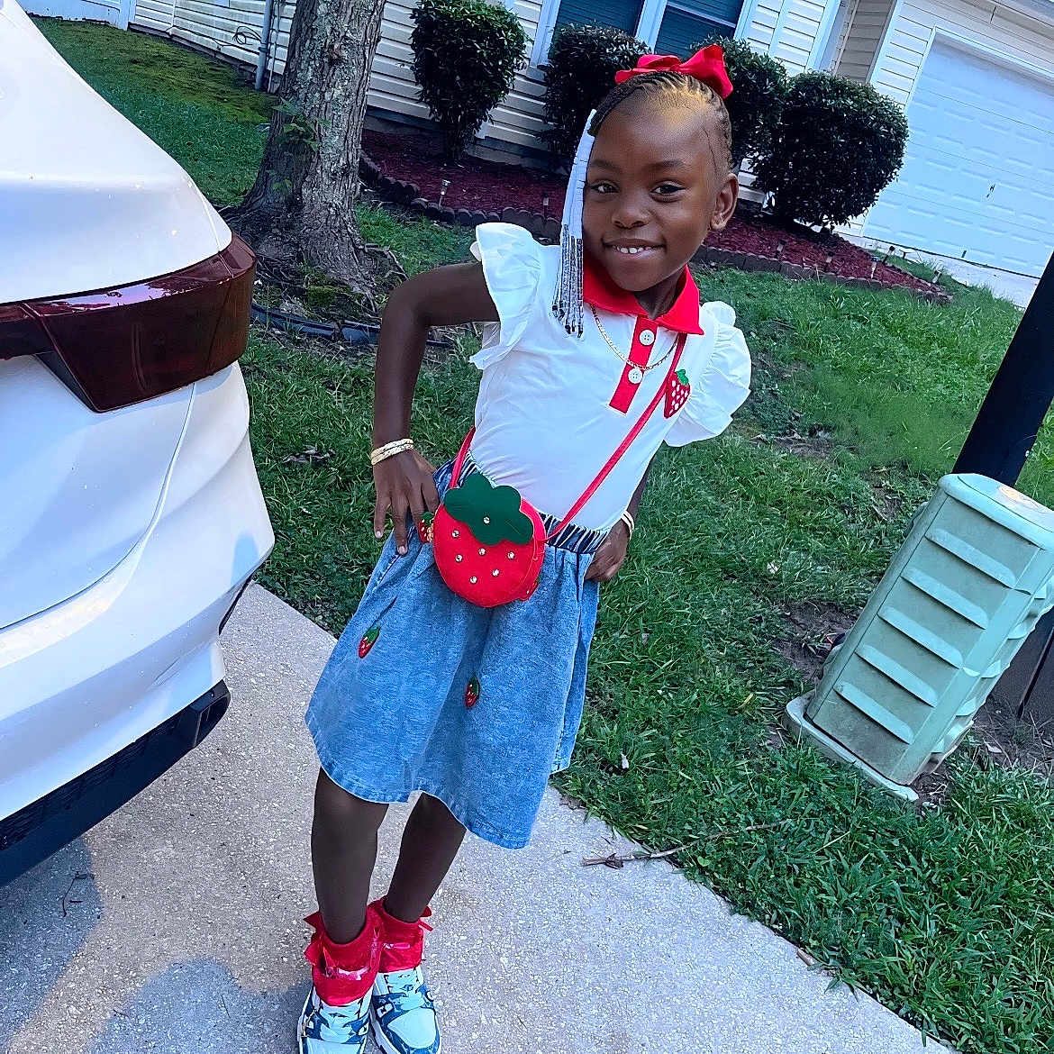 Jaliyah joined the competition — help win amazing prizes! bracelet, braids, bushes, car, casual, child, fashion, girl, grass, happy, house, outdoor, portrait, purse, red_bow, sidewalk, skirt, smiling, sneakers, tree