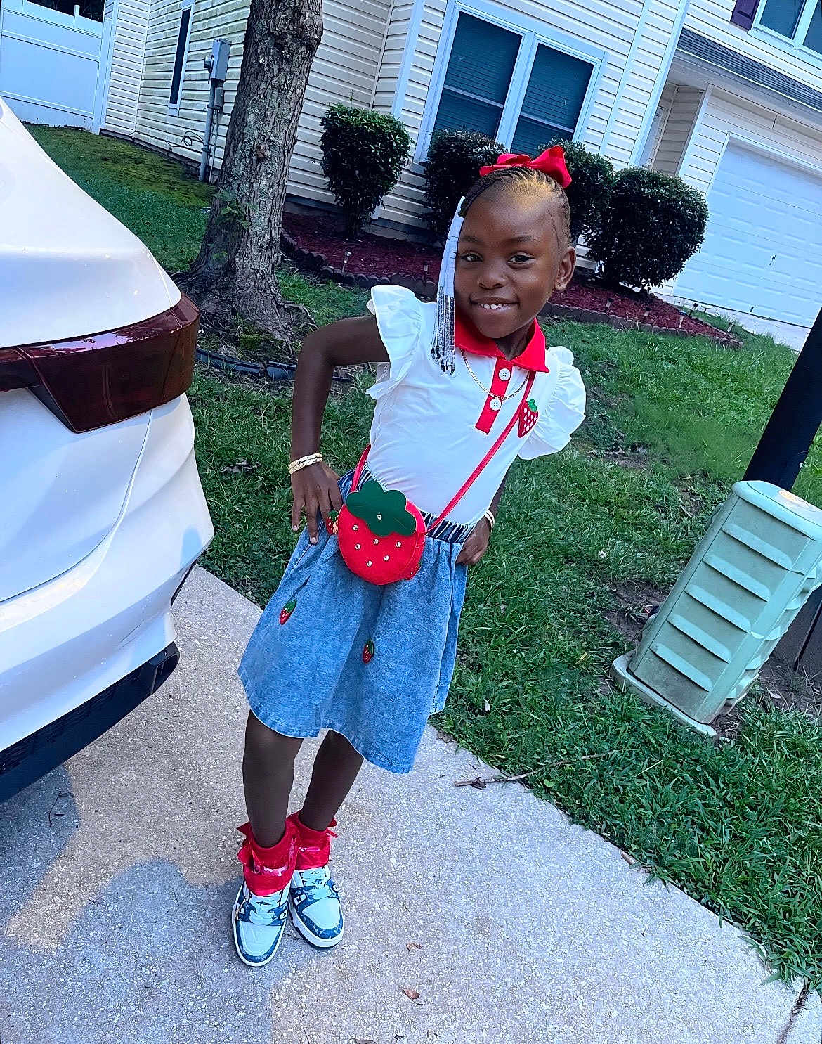 Jaliyah joined the competition — help win amazing prizes! child, girl, smiling, outdoor, sidewalk, grass, car, tree, bushes, house, purse, fashion, red_bow, braids, sneakers, skirt, bracelet, happy, portrait, casual