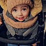toddler, child, smiling, hat, hood, jacket, stroller, blue_jeans, cozy, winter_clothing, happy, cute, baby, face, eyes, hands, seated, warm, outerwear, portrait
