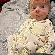 Elijah joined the competition — help win amazing prizes! baby, infant, onesie, blanket, sleepwear, face, head, person, child, cozy, expression, cute, indoors, soft, comfort, rest, young, skin, lying_down, warm