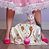 accessory, bow_collar, cat, cute, fashion, flooring, fragrance, handbag, indoor, kitten, louis_vuitton, perfume_bottle, person_legs, pink_shoes, pink_skirt, silk_cloth, star_pattern, tattoo, white_cat, wooden_floor