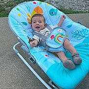 Keeton joined the competition — help win amazing prizes! baby, smiling, baby_rocker, outdoor, concrete, grass, colorful, seat, infant, happy, clothing, sock, playful, pattern, child, person, young, cute, strap, blue