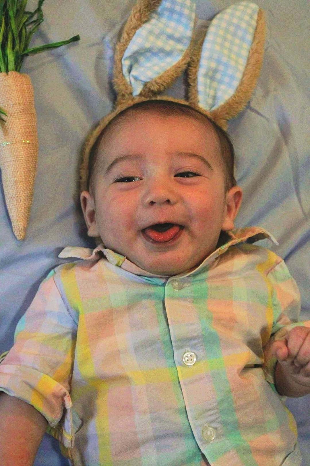 Reid is registered to the contest to win money with this photo: baby, cheek, child, chin, eye, fawn, fun, grass, happy, head, iris, mouth, nose, organ, person, skin, smile, textile, toddler, white