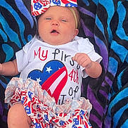 Autumn joined the competition — help win amazing prizes! baby, infant, bow, headband, clothing, blanket, patterned_blanket, face, legs, feet, american_flag, cute, celebration, 4th_of_july, summer, portrait, child, newborn, lying_down, colorful