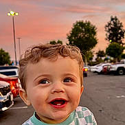Parker joined the competition — help win amazing prizes! toddler, child, smiling, curly_hair, checkered_shirt, yin_yang, outdoor, parking_lot, cars, sunset, sky, trees, happy, person, cute, baby, expression, shopping_cart, evening, urban