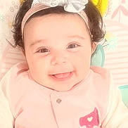 Marissa joined the competition — help win amazing prizes! baby, child, infant, smiling, happy, portrait, face, headband, bow, pink_clothing, lying_down, blanket, patterned_background, indoor, close_up, dark_hair, brown_eyes, adorable, baby_photography, joy