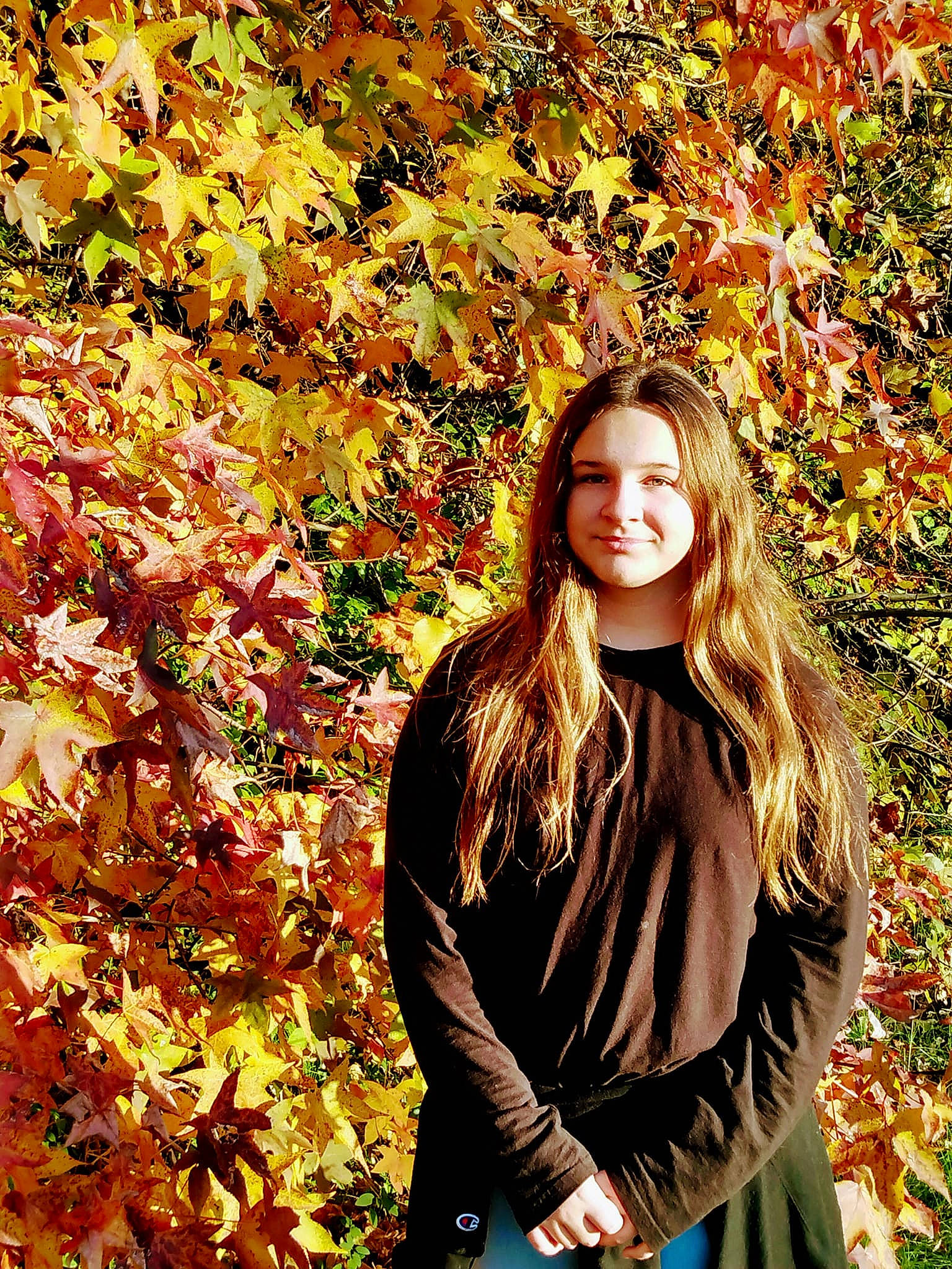 Madison is registered to the contest to win money with this photo: branch, brown_hair, deciduous, facial_expression, flash_photography, grass, happy, head, joy, long_hair, natural_landscape, orange, pattern, people_in_nature, person, plant, sleeve, smile, street_fashion, tree