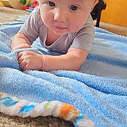 Austyn joined the competition — help win amazing prizes! baby, blanket, blue, carpet, child, cute, face, floor, furniture, infant, indoors, laying, looking, person, plush, soft, toy, wood, young, toddler