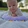 baby, blanket, blue_eyes, child, closeup, curious, cushion, daylight, face, grass, hands, head, infant, nature, outdoor, portrait, purple, smile, soft, young