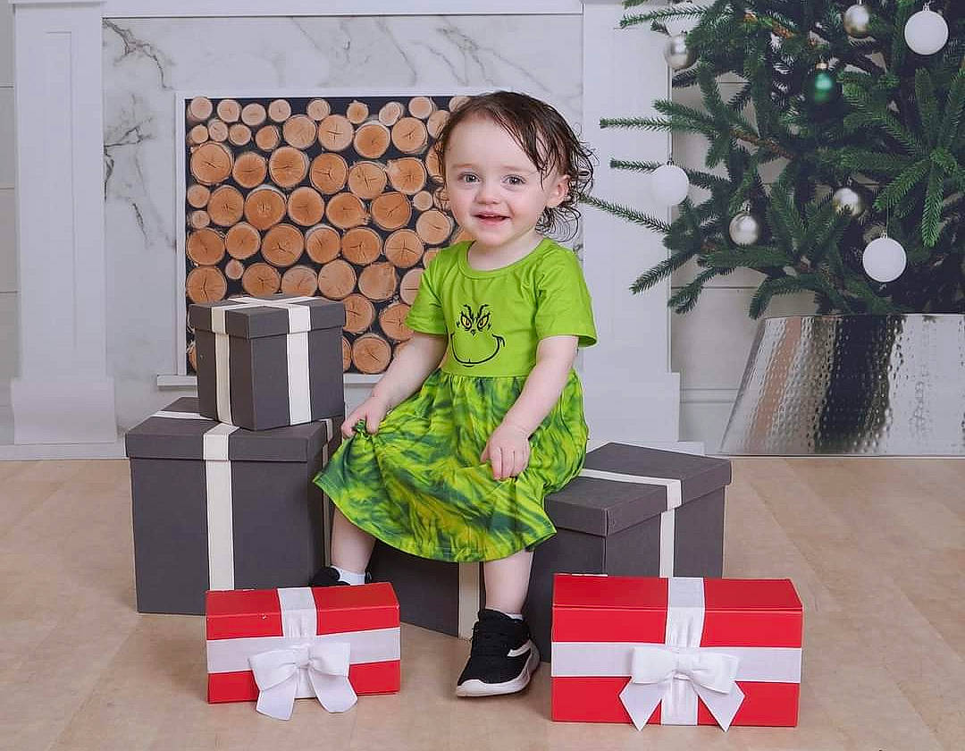 Freya is registered to the contest to win money with this photo: baby_toddler_clothing, beauty, carmine, child, design, event, flooring, holiday, joy, living_room, pattern, person, plant, product, rectangle, room, sitting, sleeve, smile, snapshot