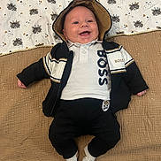 Rafaël participe au concours pour gagner de l'argent avec cette photo : baby, child, smiling, hoodie, jacket, blanket, pattern, raccoon, clothing, socks, cute, happy, infant, person, lying_down, casual, portrait, indoors, comfortable, cute_outfit