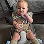 baby, baby_seat, carpet, child, clothing, couch, cute, floor, furniture, home, indoor, infant, knees, person, ruffles, serious_expression, sitting, socks, teething_toy, toy