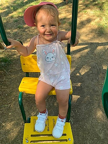 Théa participe au concours pour gagner de l'argent avec cette photo : baby_toddler_clothing, child, eye, face, facial_expression, fun, grass, happy, joy, leisure, person, playground, playground_slide, product, recreation, shorts, skin, smile, snapshot, swing