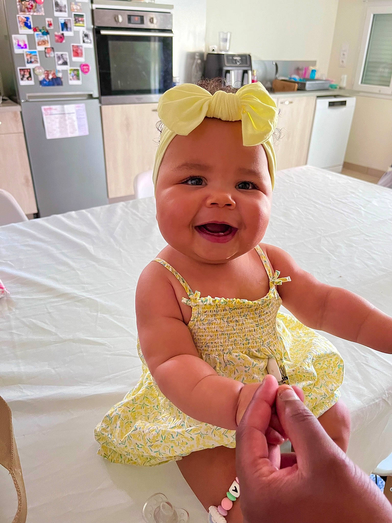 Emilia participe au concours pour gagner de l'argent avec cette photo : baby, baby_toddler_clothing, cabinetry, child, costume, event, finger, fun, happy, hat, head, headwear, home_appliance, nail, peach, person, room, smile, thumb, toddler