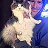 Akela joined the competition — help win amazing prizes! cat, person, hoodie, indoor, fluffy_cat, long_hair, smile, pet, animal, feline, portrait, cute, holding, friendship, companion, cozy, casual_clothing, happy, domestic_animal, furry