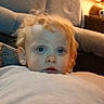 Hudson joined the competition — help win amazing prizes! toddler, child, blanket, couch, lamp, indoor, curly_hair, blue_eyes, soft_light, cozy, home, furniture, portrait, young_child, expression, cushion, relaxing, warm_lighting, person, casual