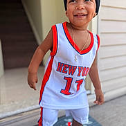 Ryan Nathael joined the competition — help win amazing prizes! child, toddler, smiling, portrait, basketball_jersey, sportswear, beanie, sneakers, cross_necklace, outdoor, doorway, house, doormat, standing, happy, face, fashion, athletic, number_17, new_york
